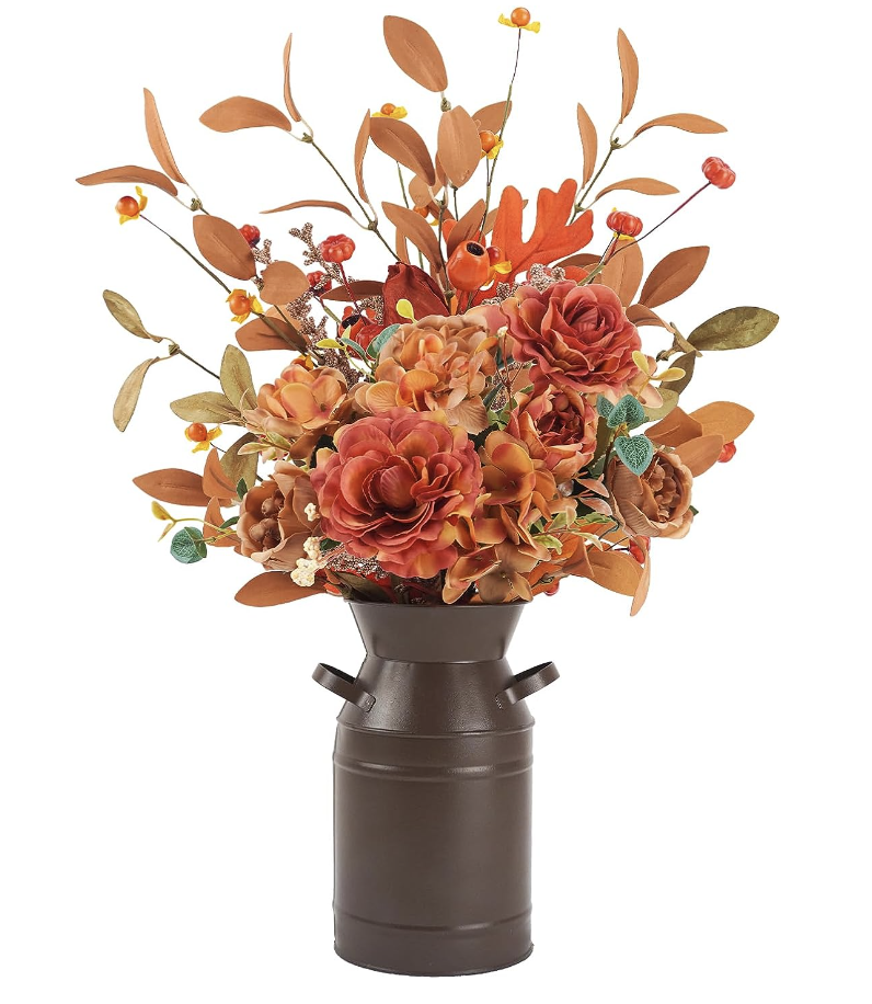 metal vases with orange, yellow, and brown faux flowers. 