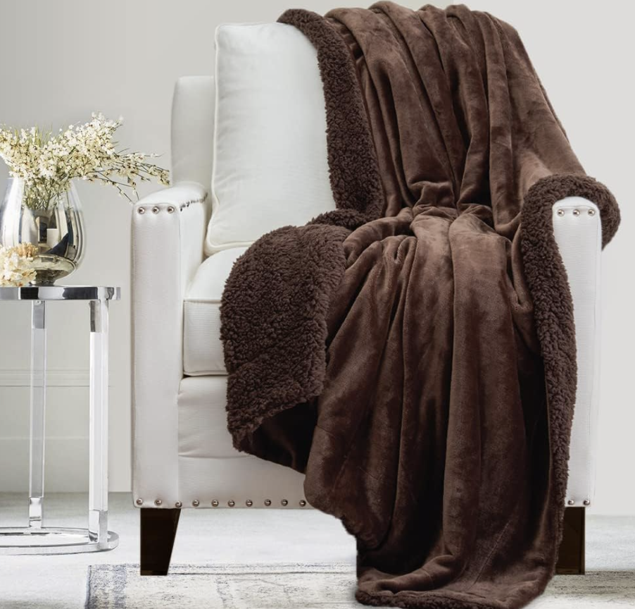 brown velvet blanket placed over a white arm chair.