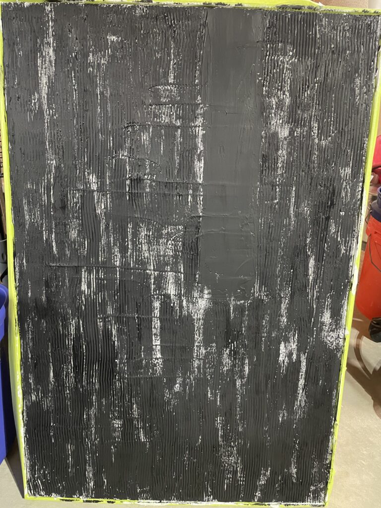 first layer of black paint on the plaster set surface. 