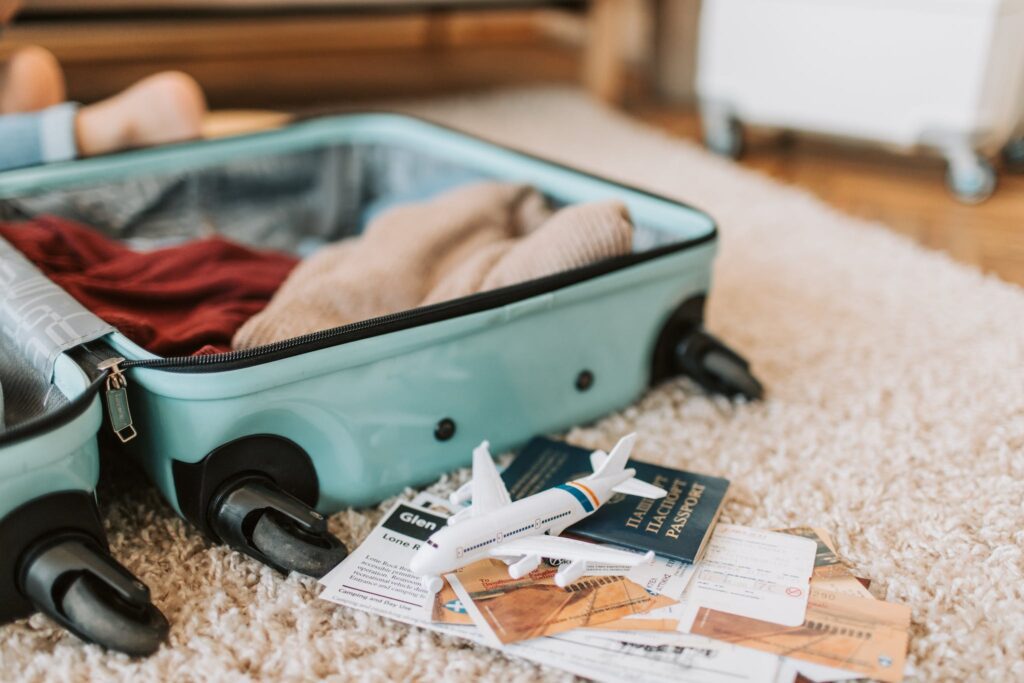 Black and Green Luggage Bag on Brown Carpet. travel packing hacks to perfectly pack the suitcase.