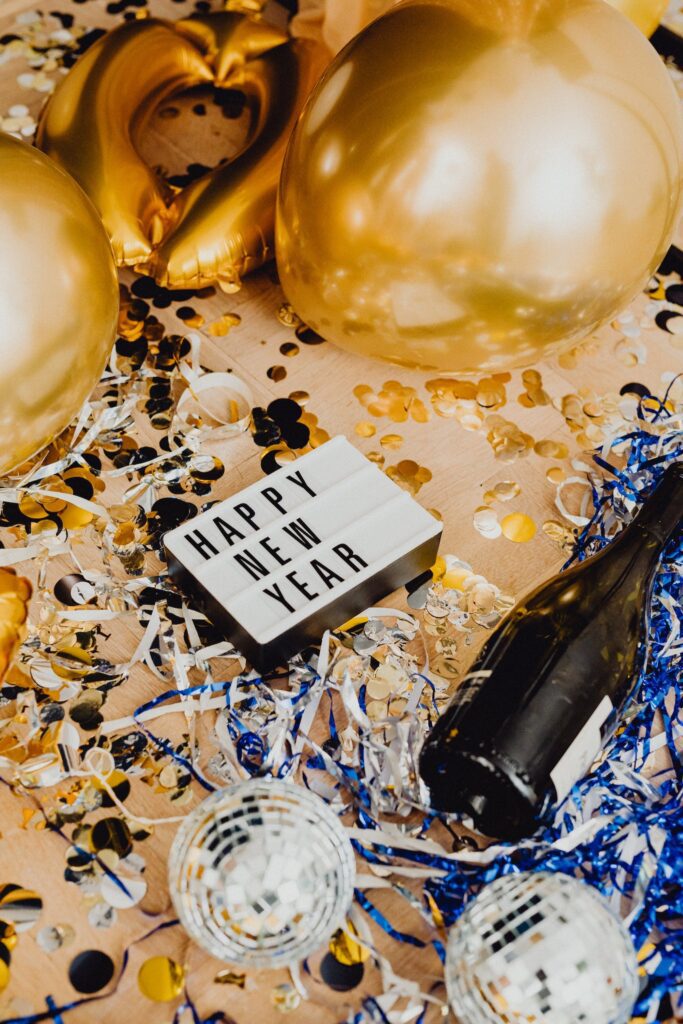 Decor and Confetti on the Floor. There is a sign that says happy new year. Motivation to find ways to keep your new year resolutions.