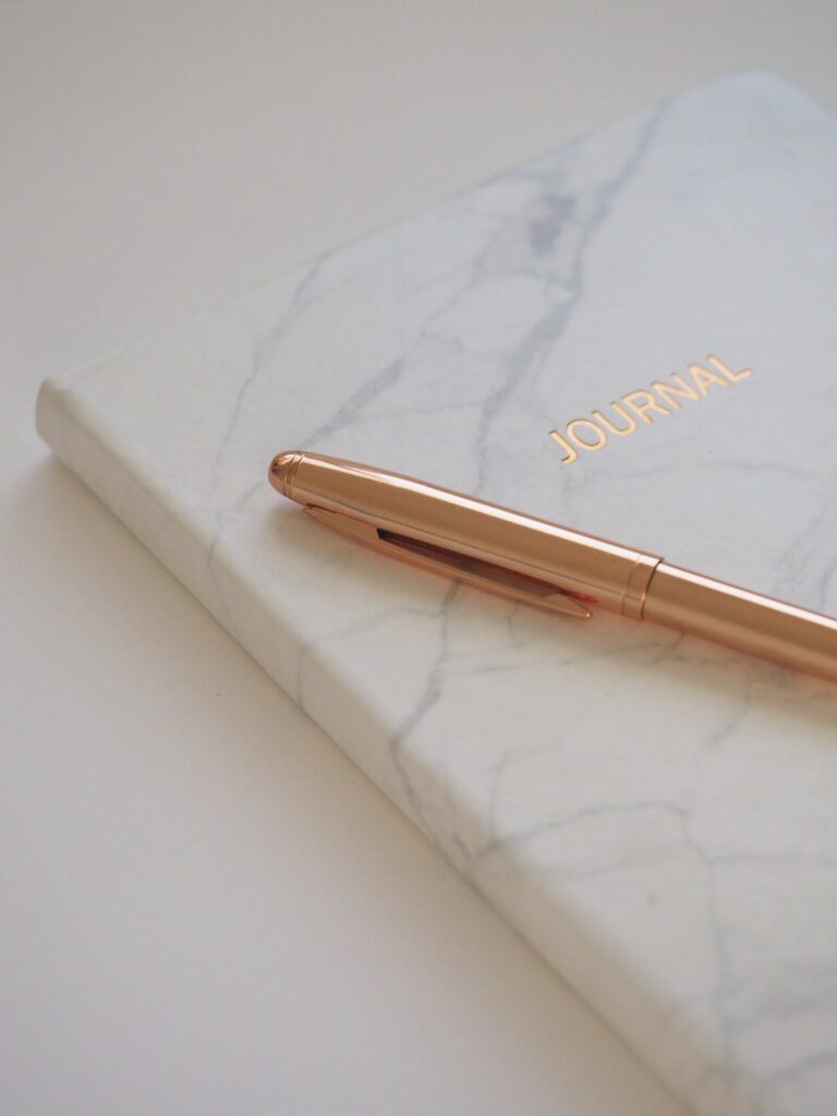 Gold Pen on Journal Book. Perfect journal for writing new year 2024 journal prompts.