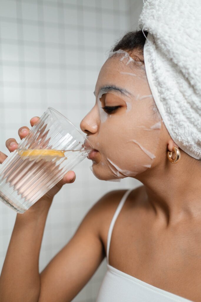 Woman Drinking Water With Lemon. You can use self care to help not spread yourself too thin