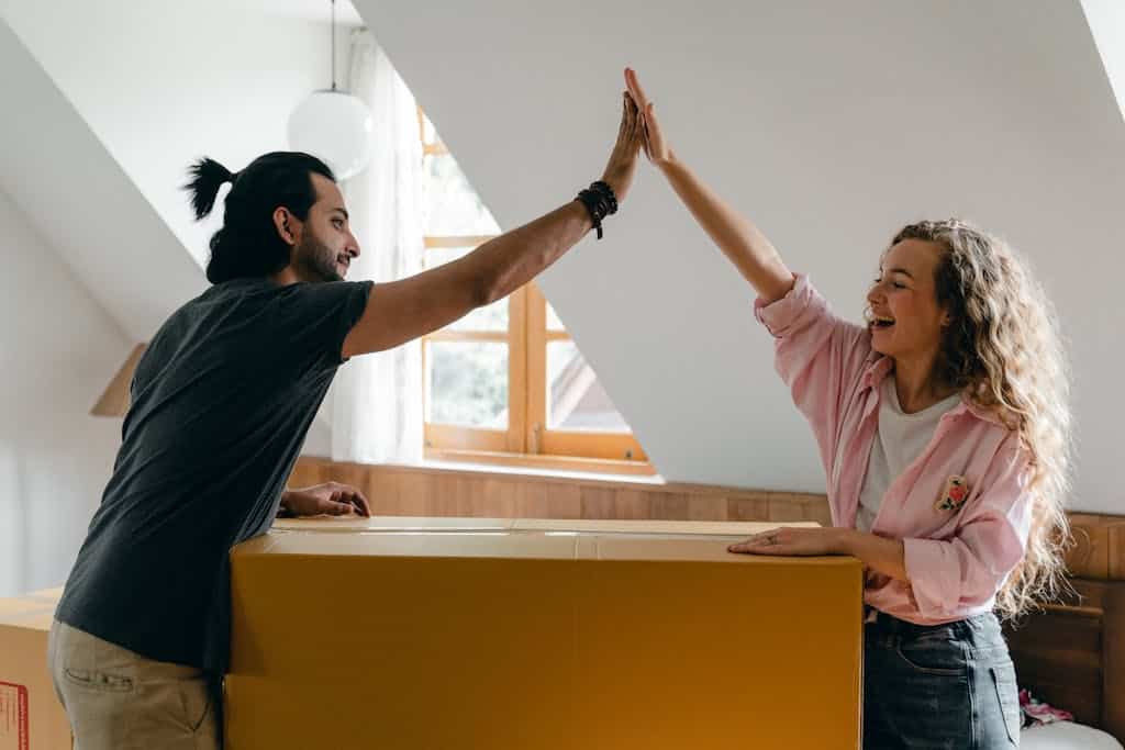 Exited diverse couple relocating in new apartment. They are planning a move to your new home